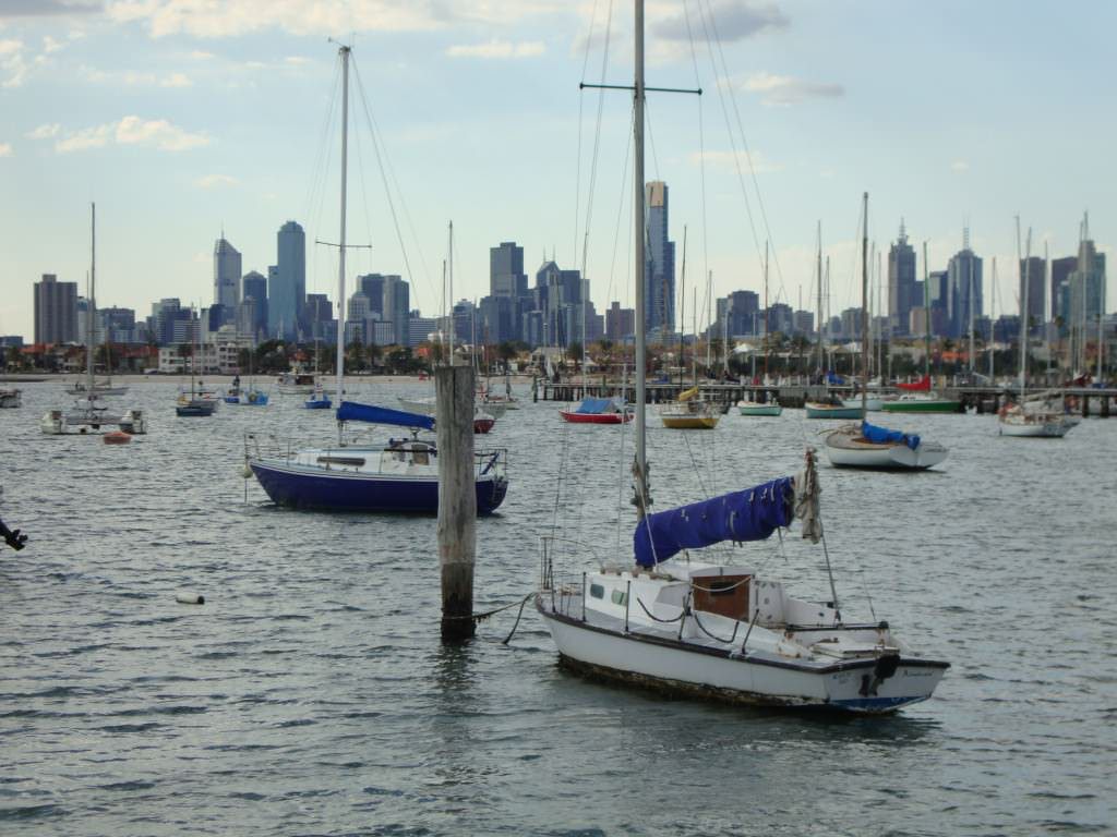 View of Melbourne, Australia from St. Kilda beach. Flights from the USA and Europe take a full day with connections, but pay close attention to that cheap fare because it could take you 40 hours to get there. how to book the cheapest flight