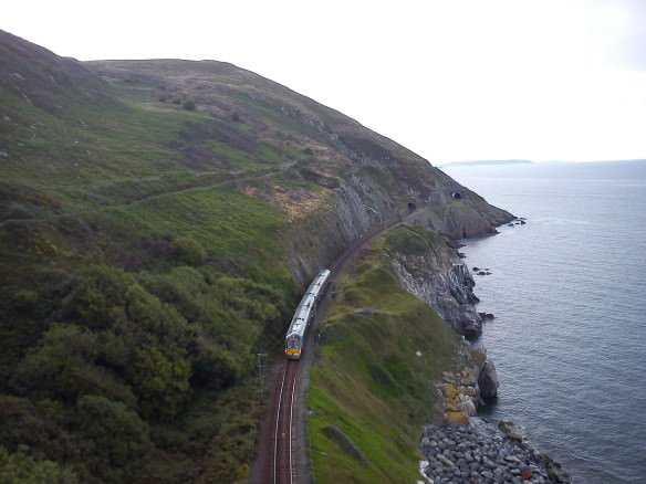 train going along the track on a cliff near Bray