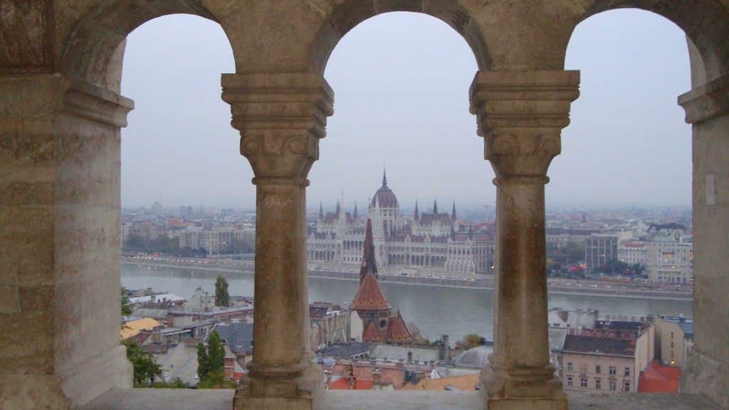 view of Budapest parliament, through the columns of Fisherman's Bastion