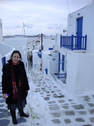 Bell in the lane-way of Mykonos with white and blue houses