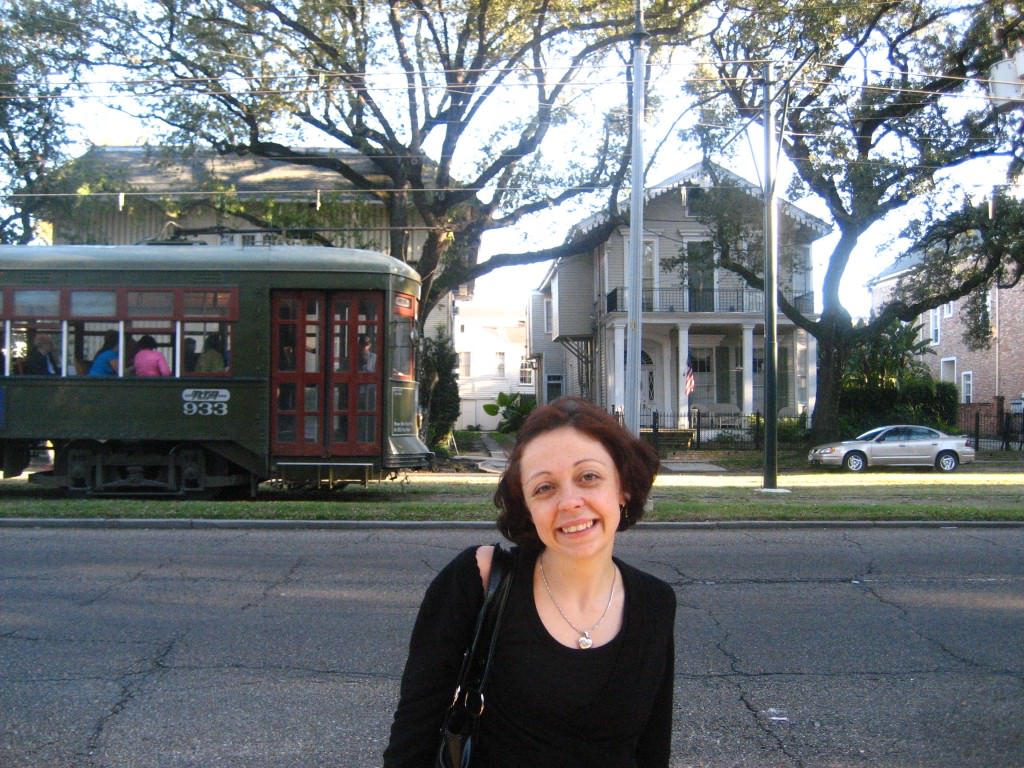 Bell poses as an old street car rolls through the Garden District, New Orleans.