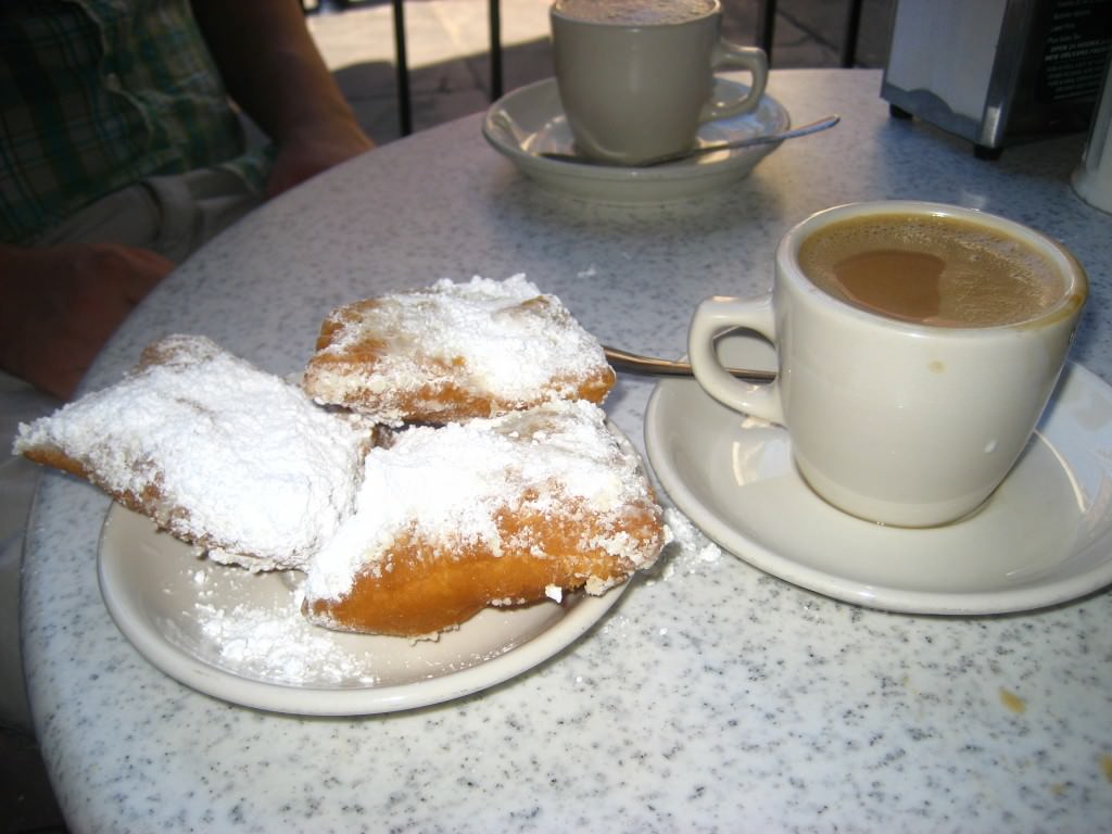 Beignets and café au lait at the famous Cafe Du Monde. New Orleans.