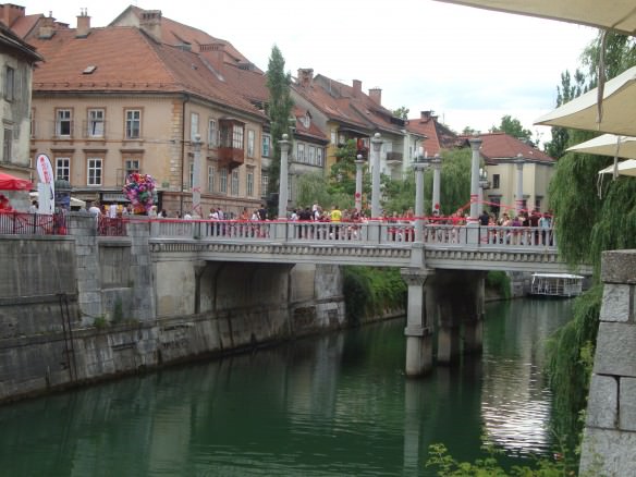 The beautiful green colored Ljubljana River  dissects the center of Ljubljana, Slovenia. mainstream travel advice