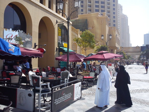 Emiratis walking along ritzy Jumeirah, checking out IHOP.