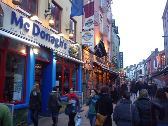 Quay Street in Galway with many people walking down the street