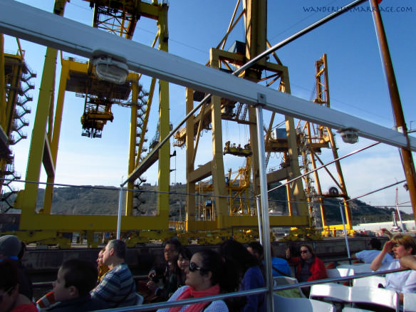 Harbour tour, view from the boat with the cranes from the shipping docks