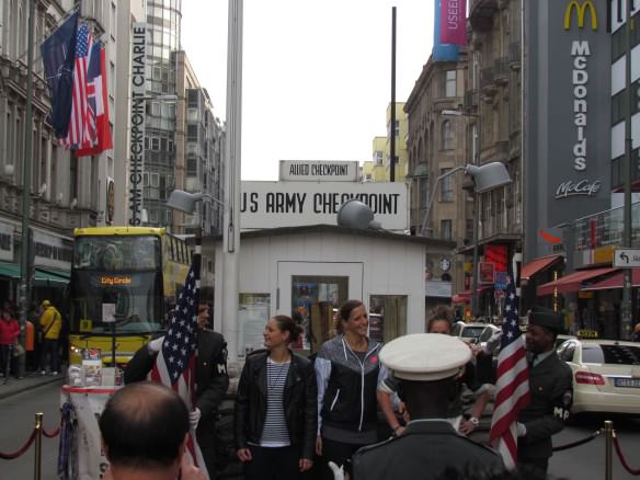 tourists posing for photos at Checkpoint Charlie, with McDonalds in the background