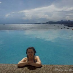 Bell in the infinity pool at the Sheraton with a sweeping view overlooking Sandakan, Borneo.