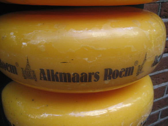 large cheese wheels stacked in Alkmaar