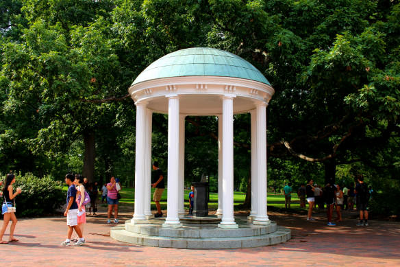 students mingling around the Old Well at UNC-Chapel Hill