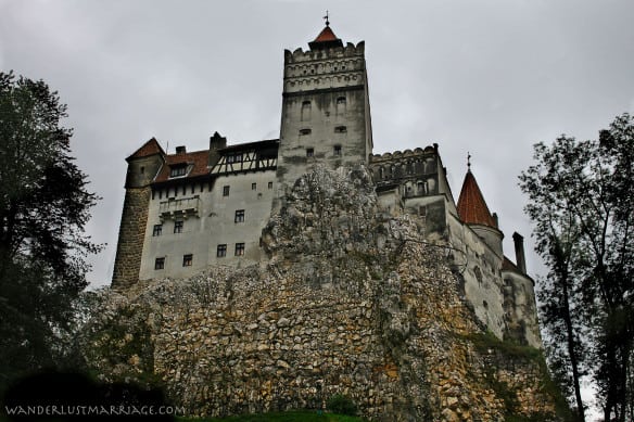 Photo of a castle upon some rocks with a grey sky