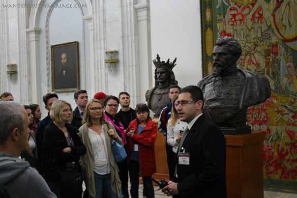 The Palace of Parliament tour guide explains the history to visitors on our tour