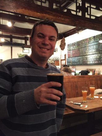 Alex with a beer at Great Leap Brewing Beer