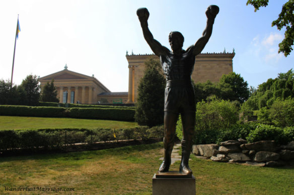 Rocky Statue triumphantly raising his arms in front of the Philadelphia Museum of Art