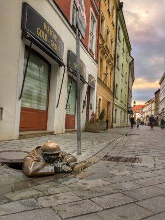 Man in a street hole - sculpture in the streets