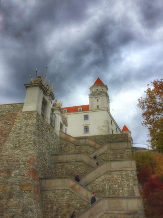 Bratislava castle with stormy skies and autumn leafs