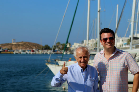 Alex and his dad at the Naxos harbor and boats in the background