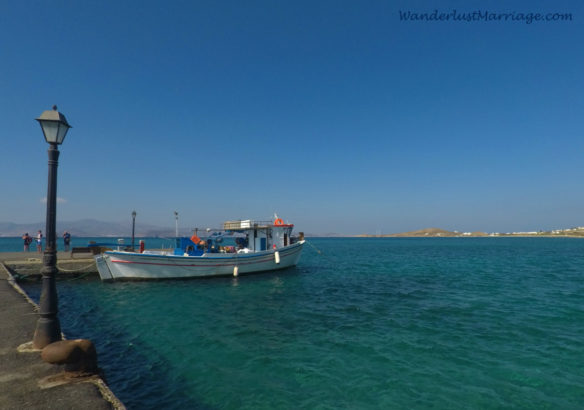 Boat docked at the pier and the blue/green sea