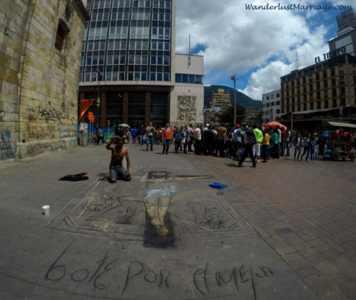 artist drawing Jesus in chalk on the street in Bogota, Colombia