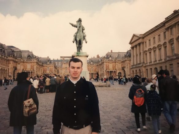 Alex in Paris 20 years in front of a statue of Napoleon