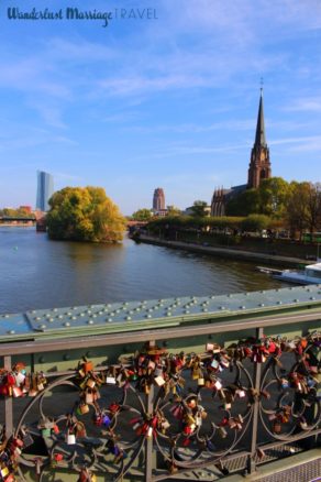 River Main with the cathedral and locks on the bridge with a blue sky