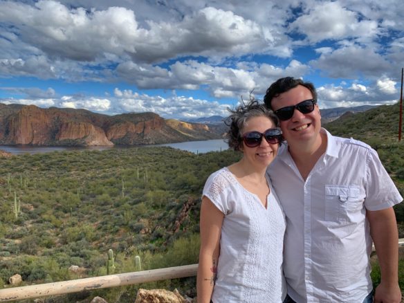 Alex and Bell in front of lake and red rocks along the Apache Trail