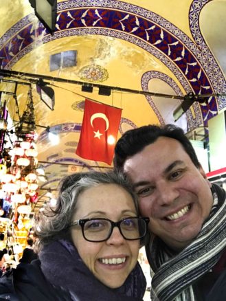 Alex & Bell selfie inside the Istanbul bazaar market with lamps in the background