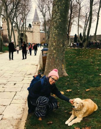 Bell petting a golden retriever dog out the front of Topkapi 