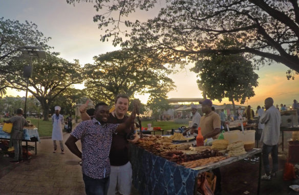 Alex with a vendor at his stall at the night market