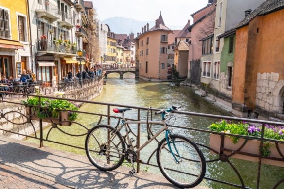 Bike leaning up against the bridge of canal in Annecy 