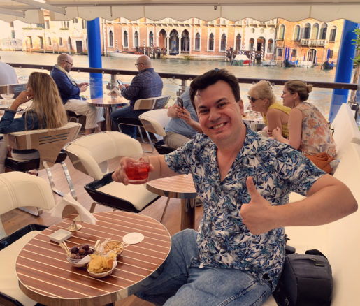 Alex drinking an aperol spritz on the terrace of Gritti Palace