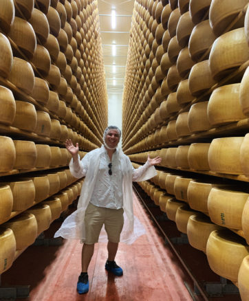 Alex with wall to wall parmesan cheese wheels