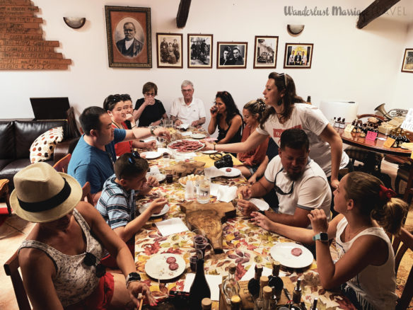 Tour group around a table tasting balsamic vinegar