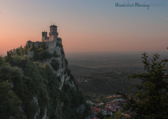 Fort a top a cliff at dusk with pink skies