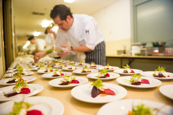 Chef putting together plates of food 