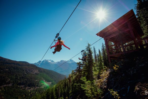 Zipping person in Whistler with the sunshining down on them