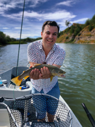 Alex with his brown trout catch while fly fishing on on the Bighorn River 