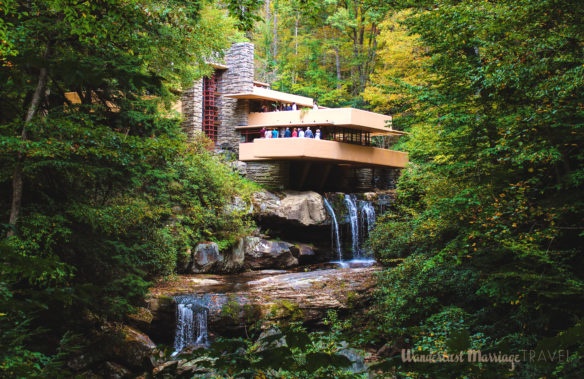 The exterior of Frank Lloyd Wright's Fallingwater with the fall foliage and waterfalls