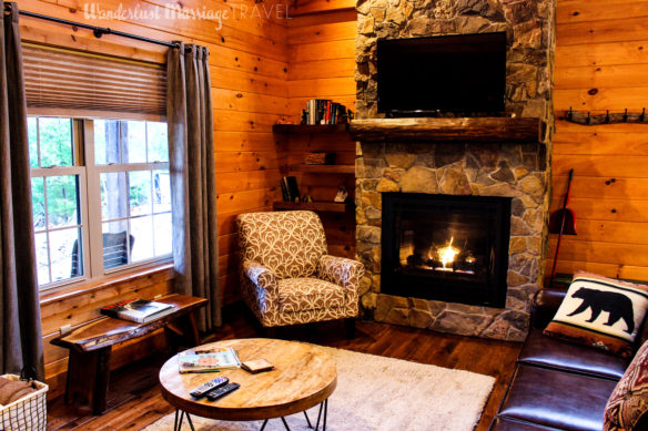 Cabin room with fire and comfy chairs