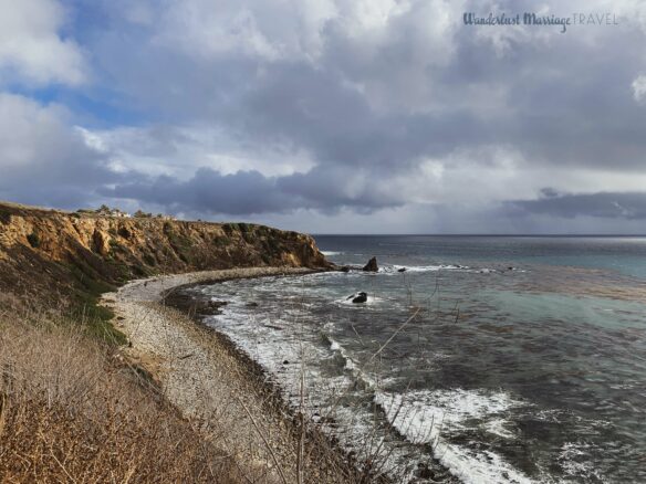 Rugged cliffs and Pacific Ocean with moody clouds for a hike on the weekend in LA