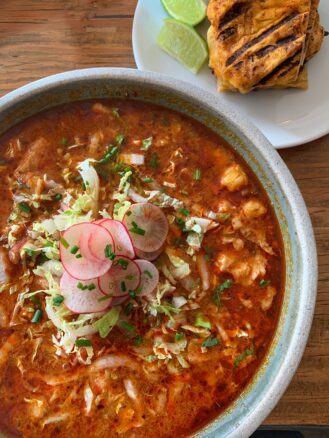 Bowl of chimayo posole top with radishes