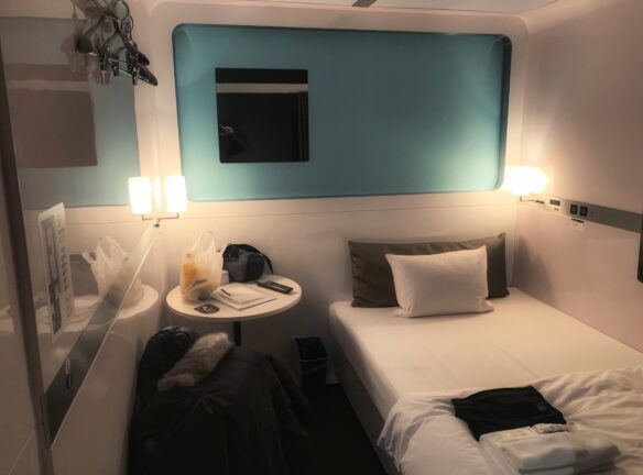 Cabin room, here there is a bed with a bedside table and enough room to walk around