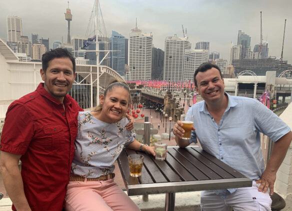 Alex and friends enjoying a beer with the sydney skyline