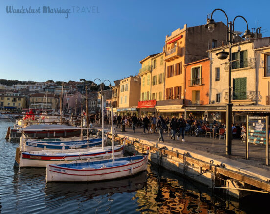 Harbor with boats and restaurants bathed in golden sunlight