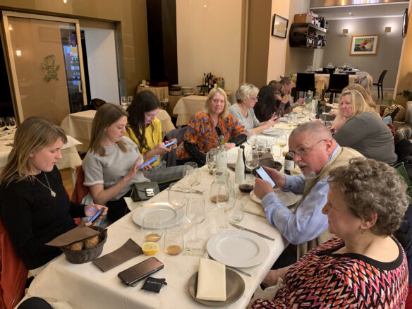 Table of conference attendees on their phones