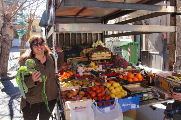 tour guide Grazia discusses fresh fruit and vegetables in Militello, Sicily like mandarins and artichokes. 