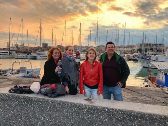 four travel bloggers drinking wine on the port of Catania