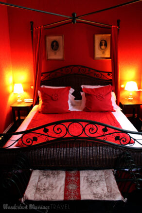 Four poster bed with red walls and red bed spread at Hotel de la Bretonnerie