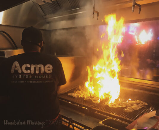 Chef flame grilling oysters at Acme oyster house