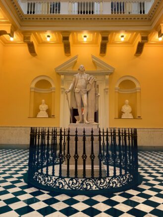 Statue of George Washington. Surrounded by black and white tiles in the Virgina State House
